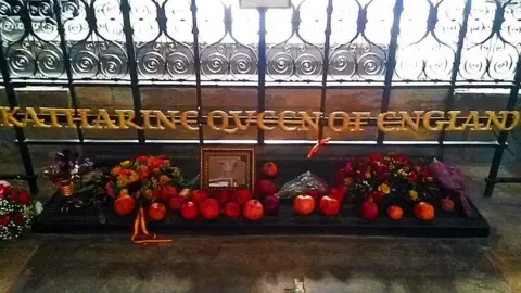 Peterborough Cathedral Grave with sign and fruit and flowers