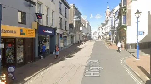 High Street, Ilfracombe - a two-lane town centre road with shops either side