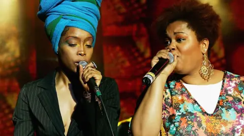 Getty Images Erykah Badu, and Jill Scott, perform as part of the Sugar Water Festival at the Greek Theatre on August 9, 2005 in Los Angeles, California.