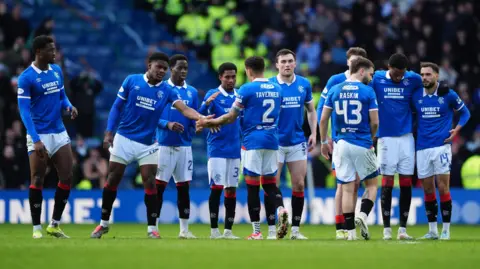 PA Media Rangers players on the pitch during the penalties. 
