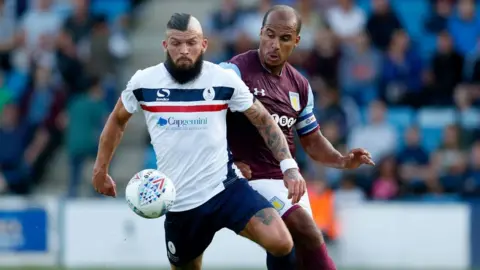 Getty Images Shane Sutton of AFC Telford United competes with Gabriel Agbonlahor of Aston Villa