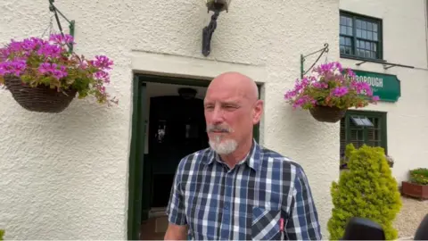 Brendan Watkins standing outside the Peterborough Arms in Dauntsey Lock