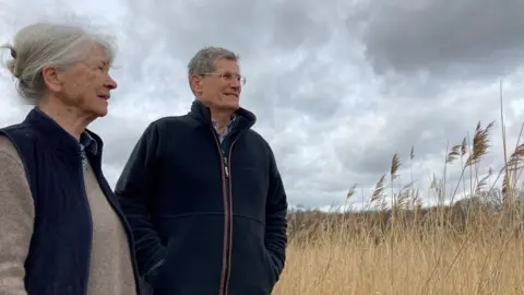 BBC Angelika and Tim Harris stand in the Norfolk Broads