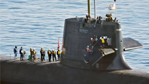 Newscom/Alamy Live Workers assess the damage