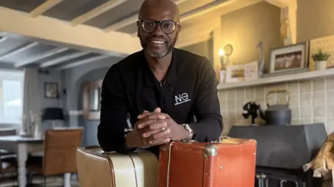 BBC Sean Wharton with the suitcases used by his cousins