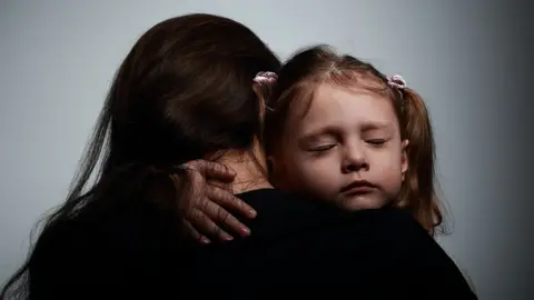 Getty Images Mother hugging her daughter