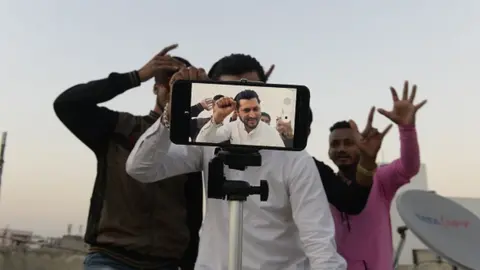 Getty Images Young Indian men making a TikTok video in Hyderabad.