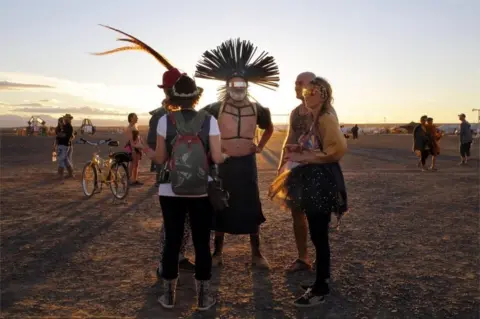 EPA Festivalgoers wear radical self-expression costumes at the annual Afrikaburn Festival held in the Tankwa Karoo, Calvinia, South Africa, 24 April 2018 (issued 25 April 2018). The 2018 AfrikaBurn Festival, a radical self-expression festival, is a regional event of BurningMan Festival and sees 13,000 people converge in the desert to build a temporary town for a week. "Burners" have to bring their own camping and survival gear and there is no money, mobile reception or commercial goods at the event.