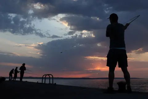 Tom Nicholson / Reuters Fishermen in the early morning light