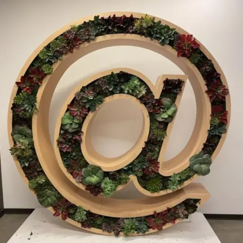 A planter shaped like the @ symbol