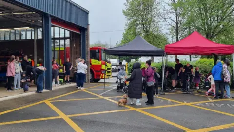 Matt Broadbent Members of the public standing outside the fire station, ready to take part in the challenge. 