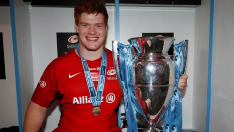 Saracens' Ralph Adams-Hale poses with the Premiership trophy