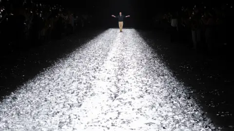 EPA Belgian fashion Designer Dries Van Noten greets the audience at the end of the presentation of his Spring/Summer 2025 Menswear Collection during Paris Fashion Wee