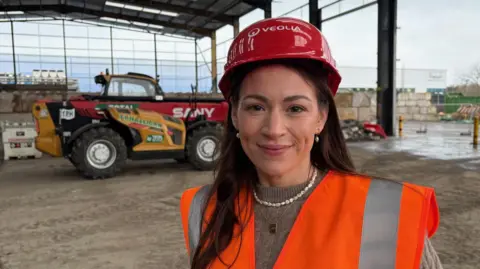 Woman in hard hat and high-vis jacket