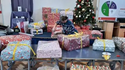 Sarah Rutter Christmas parcels in a hall