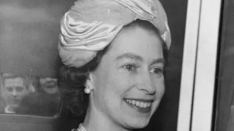 10th June 1964: Queen Elizabeth II is smiling and looking off camera as she is leaving Earl's Court, London, after opening a World Book Fair