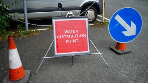 A photo of a water distribution point sign 