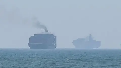 Cargo ships anchoring near the Strait of Hormuz off the eastern coast of the United Arab Emirates at Khor Fakkan on 12 July.
