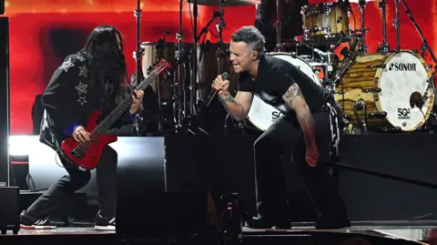 PA Media Robbie Williams on stage at the Brit Awards