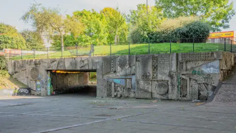 Aaron Law Abstract concrete art by artist William Mitchell includes images of circles and geometric shapes is on three sides of an underpass in Birmingham's Hockley Circus. 