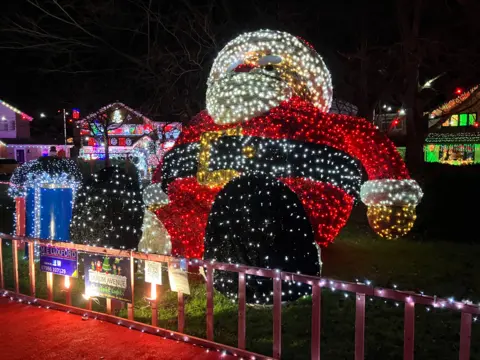 A huge Santa illuminated by lights