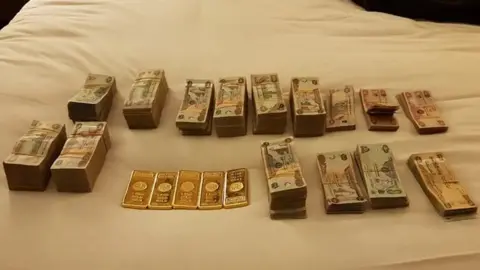 Lancashire Police Stacks of foreign notes piled on a bed

