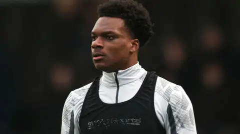Deji Elerewe warms up before a League Two match between Bromley and Colchester United