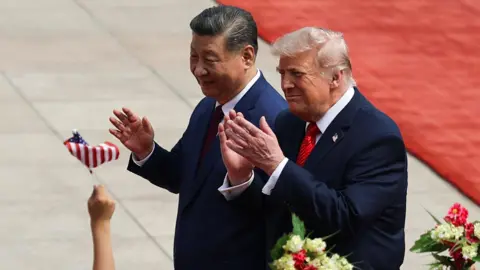 EPA Chinese President Xi Jinping and U.S. President Donald Trump react during a welcome ceremony at the Great Hall of the People