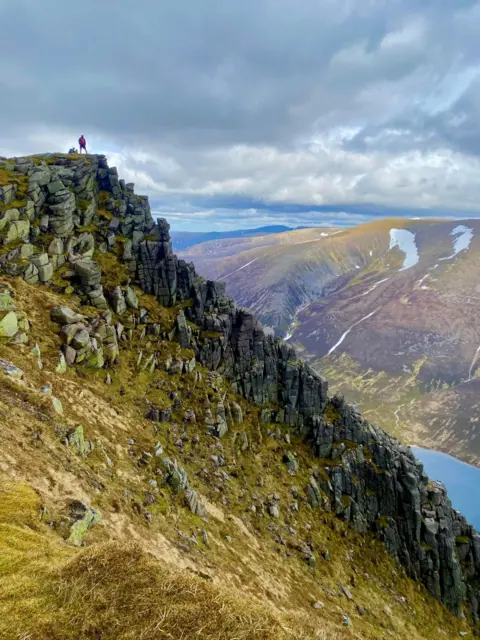 Alison Freshwater Two people in the far distance on top of a Munro