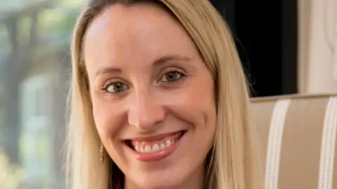 Elizabeth Marett Ms Marett looking at the camera. She has blond hair and brown eyes. 