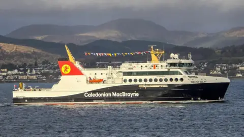 Christopher Brindle A black and white ferry on water with Caledonian MacBrayne written on it, with Isle of Islay written near the front 