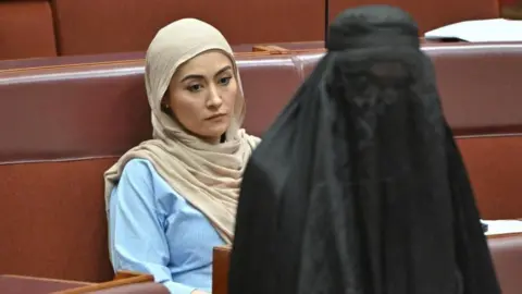 Australia senator suspended after burka stunt in parliament