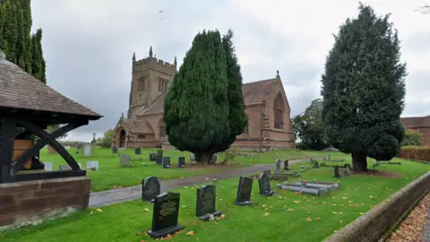 Google Maps General view of Church of St Mary, Sutton Maddockk, a historic church with grave stones on grass at the front and two large trees are visble near the gravestones