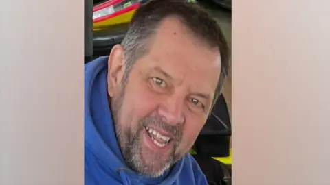 John Hinchcliffe has short grey hair and a short grey beard