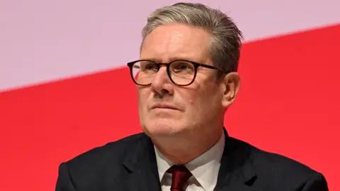 Sir Kier Starmer wearing a suit   with a achromatic  garment  and reddish  necktie  against a reddish  and achromatic  background