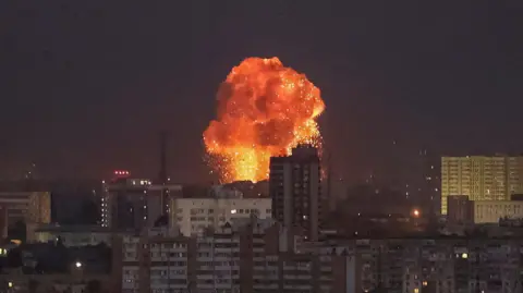 Reuters An explosion is seen in the sky above Kyiv following Russian missile strikes on the city