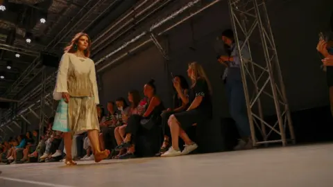 Getty Images Models present the Sashina Designer label collection during Moscow Fashion Week at Zaryade Park in Moscow, Russia on June 24, 2022.