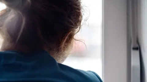 Getty Images Woman at window