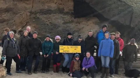 Protestors by the cliffs