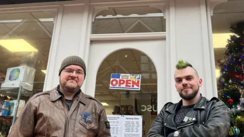 Shop-owners Aaron Purvor and Mido Ringer outside the entrance to their Pokemon merchandise story Geckos in Wrexham.