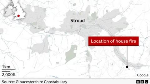 Map shows the area of Stroud in dark grey and a black dot pointing south east of the town, marking the location of the house fire.