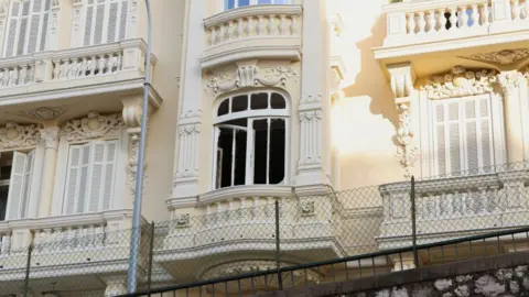 The damaged window of a residential building