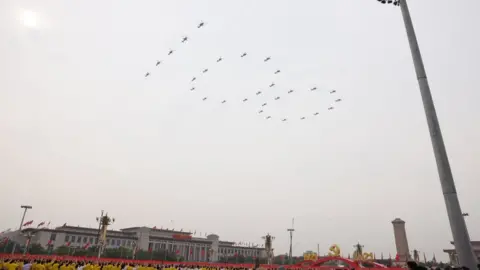 Getty Images Aircraft from the Chinese People's Liberation Army (PLA) air force fly in formation during a parade to celebrate the the 100th founding anniversary of the Chinese Communist Party at Tiananmen Square on July 1, 2021 in Beijing, China.