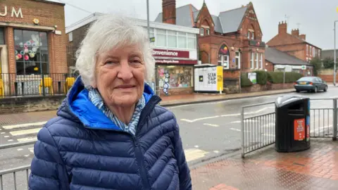 Resident of Radcliffe-on-Trent, Jerry Siverns, stood on the main road with the InPost lockers in the background.