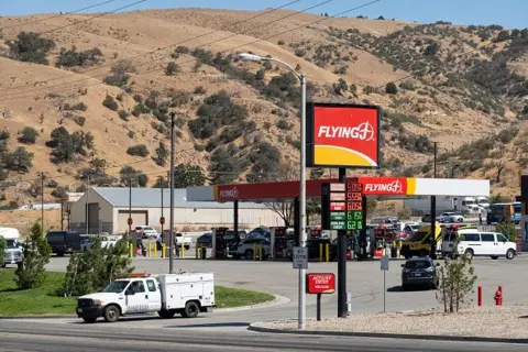 Getty Images A white truck is seen leaving a Flying J truck stop in California in a remote area surrounded by hills outside Los Angeles