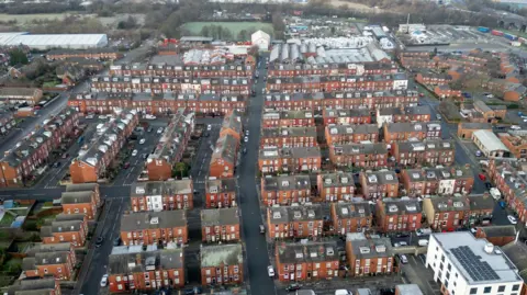 An aerial view of an area of Leeds with rows of back to back terraced houses