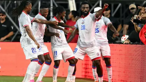 Haiti's forward #20 Frantzdy Pierrot celebrates with teammates after scoring his team's third goal during an international friendly football match between Haiti and New Zealand at Inter Miami CF Stadium in Fort Lauderdale, Florida on June 2, 2026.