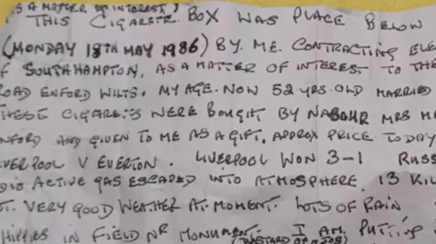 Handout The original note, written in capitol letters and black ink on a white piece of paper, now looking a bit cream.
The writing is in the style of that time that Fred would have learned at school, and is in a neat style.