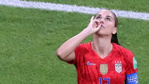 USA star Alex Morgan celebrating her goal against England