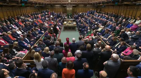 UK Parliament A packed House of Commons chamber, with many MPs standing